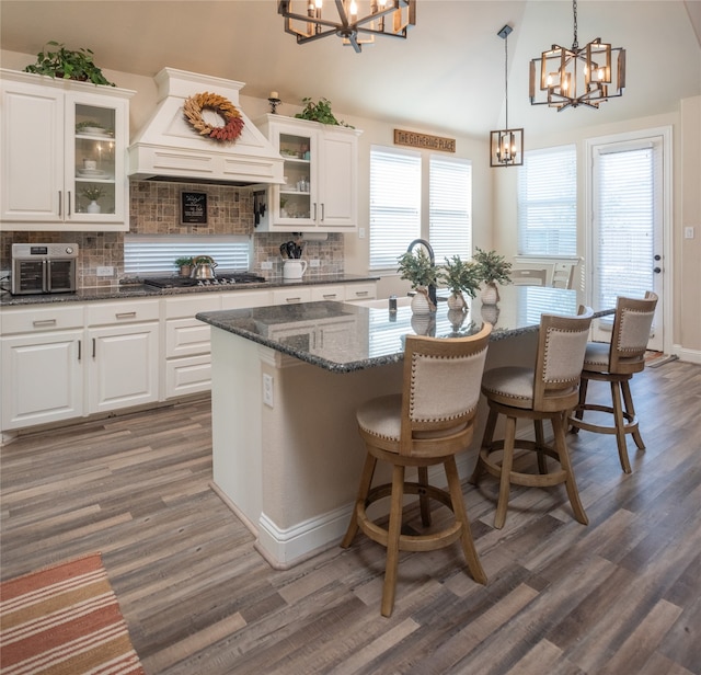 kitchen featuring premium range hood, white cabinetry, and dark wood-type flooring