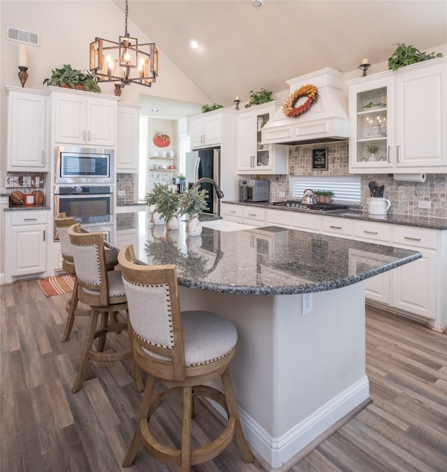 kitchen featuring white cabinets, stainless steel appliances, and a spacious island