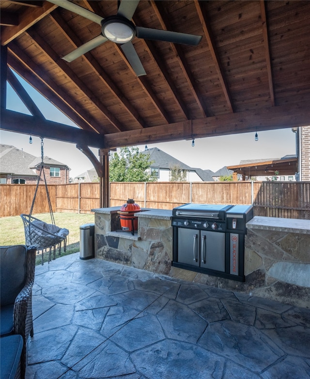 view of patio / terrace with ceiling fan and exterior kitchen