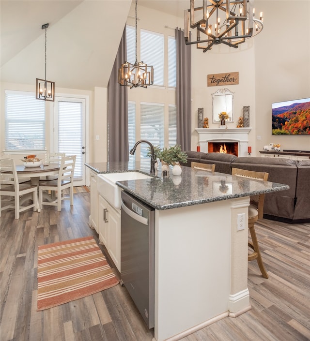 kitchen with dishwasher, sink, dark wood-type flooring, high vaulted ceiling, and white cabinets