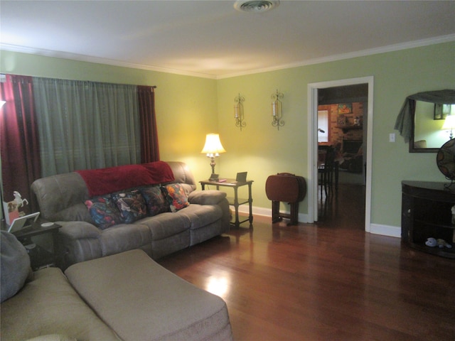 living room with dark hardwood / wood-style floors and ornamental molding