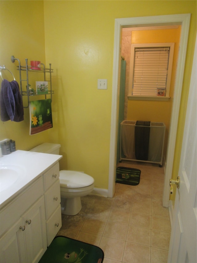 bathroom featuring walk in shower, tile patterned floors, toilet, and vanity