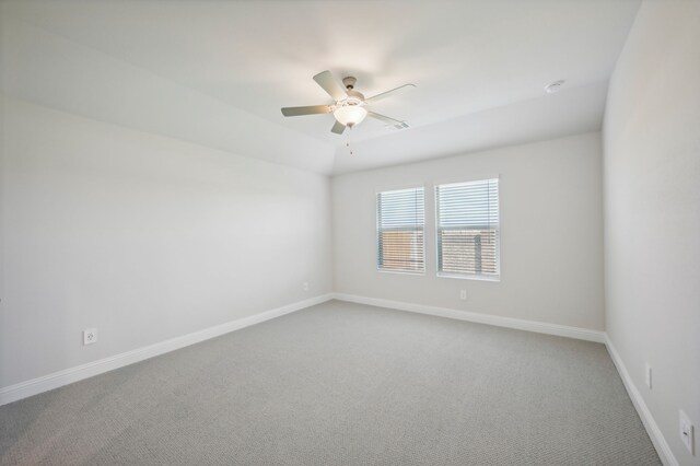 spare room with ceiling fan and carpet