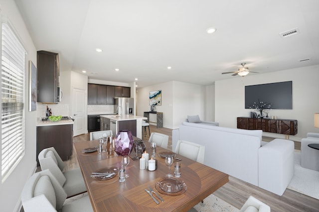 dining space featuring light hardwood / wood-style flooring and ceiling fan