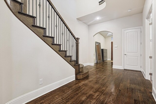 entryway with dark hardwood / wood-style flooring