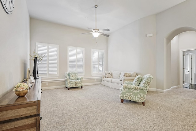 carpeted living room featuring ceiling fan and vaulted ceiling