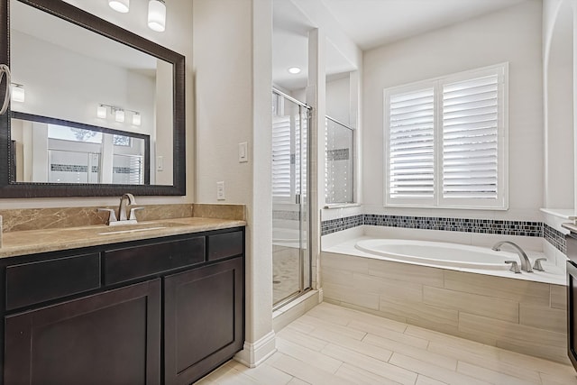 bathroom with plus walk in shower and vanity