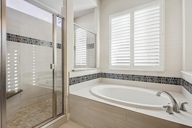 bathroom with independent shower and bath and a wealth of natural light