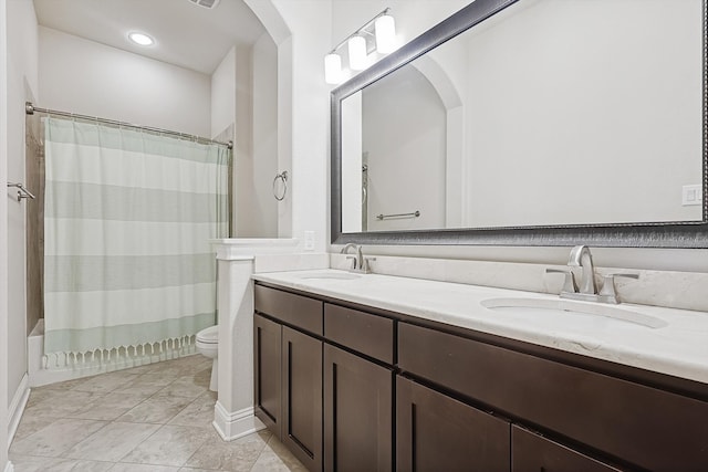 full bathroom with shower / tub combo with curtain, vanity, and toilet