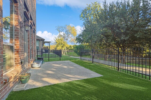 view of basketball court with a lawn