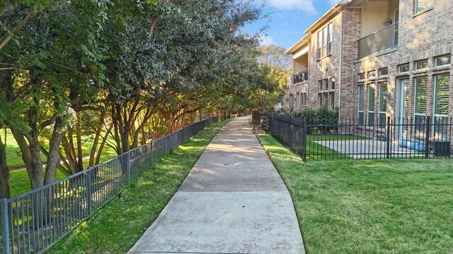 view of property's community with a lawn