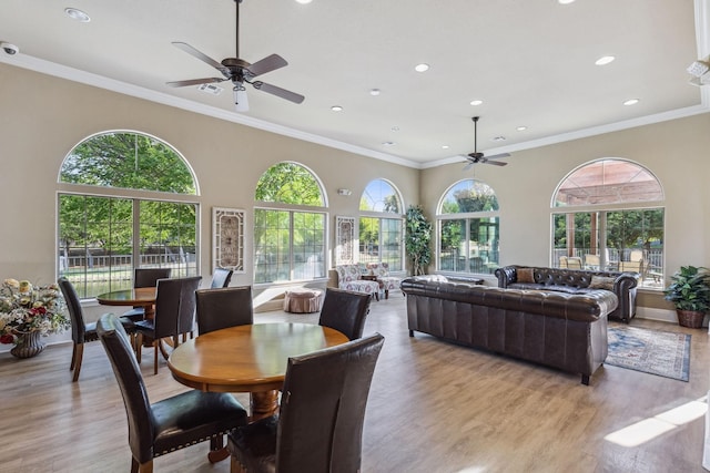 dining space with ornamental molding, light hardwood / wood-style floors, and ceiling fan