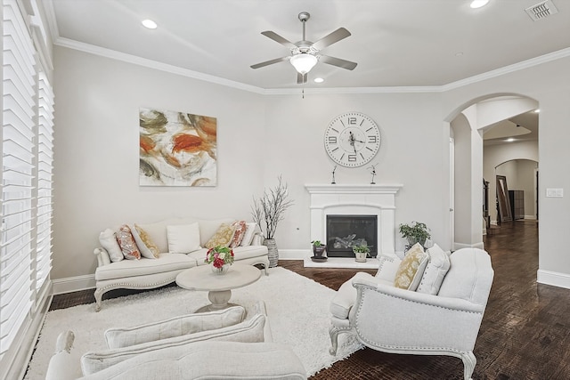 living room with ornamental molding, ceiling fan, and dark hardwood / wood-style flooring