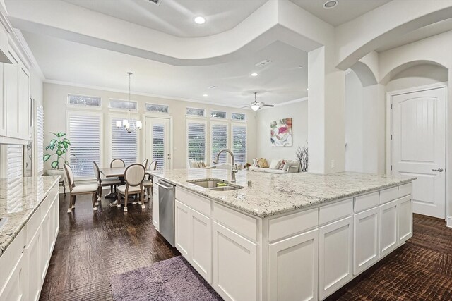 kitchen featuring hanging light fixtures, sink, and white cabinets