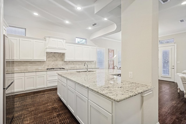 kitchen featuring crown molding, light stone countertops, sink, and white cabinets