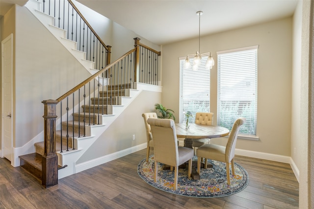 dining room featuring dark hardwood / wood-style flooring and a notable chandelier