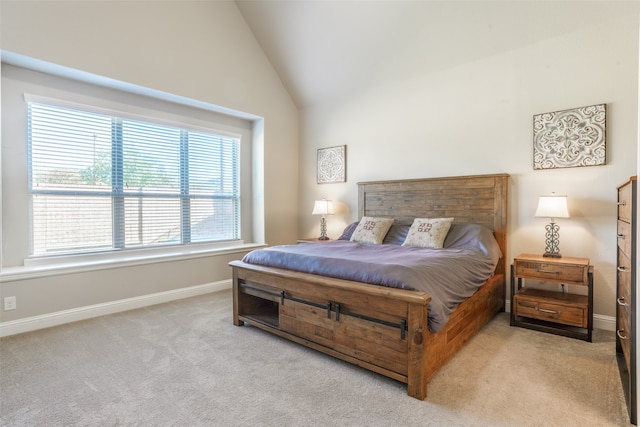 carpeted bedroom featuring multiple windows and high vaulted ceiling