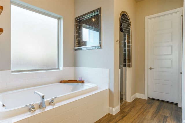 bathroom featuring separate shower and tub, hardwood / wood-style floors, and a healthy amount of sunlight