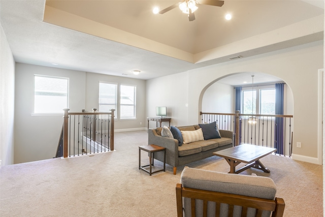 carpeted living room featuring plenty of natural light and ceiling fan