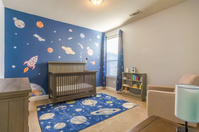 carpeted bedroom with a nursery area