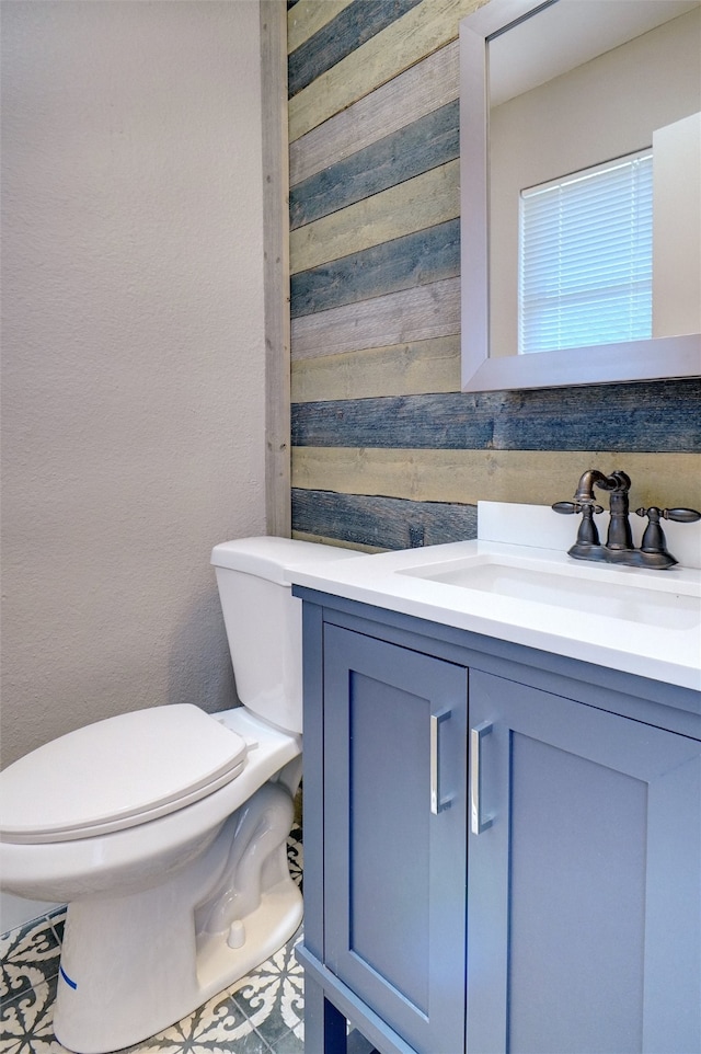 bathroom featuring tile patterned floors, vanity, and toilet