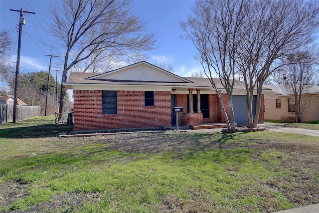 ranch-style house featuring a porch, a front yard, and a garage