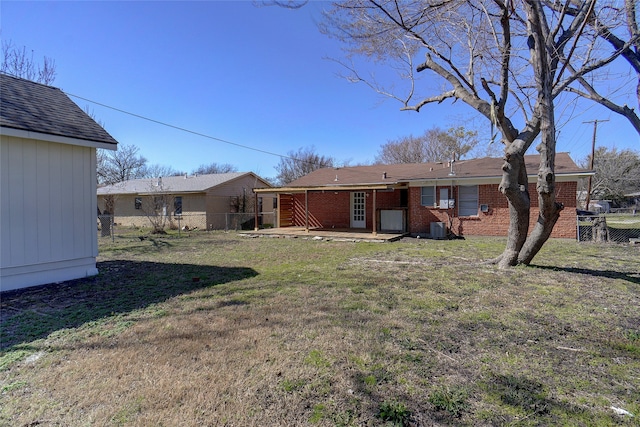 rear view of house with a patio area and a yard