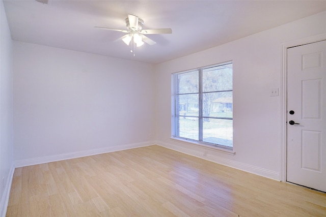 spare room with ceiling fan and light wood-type flooring