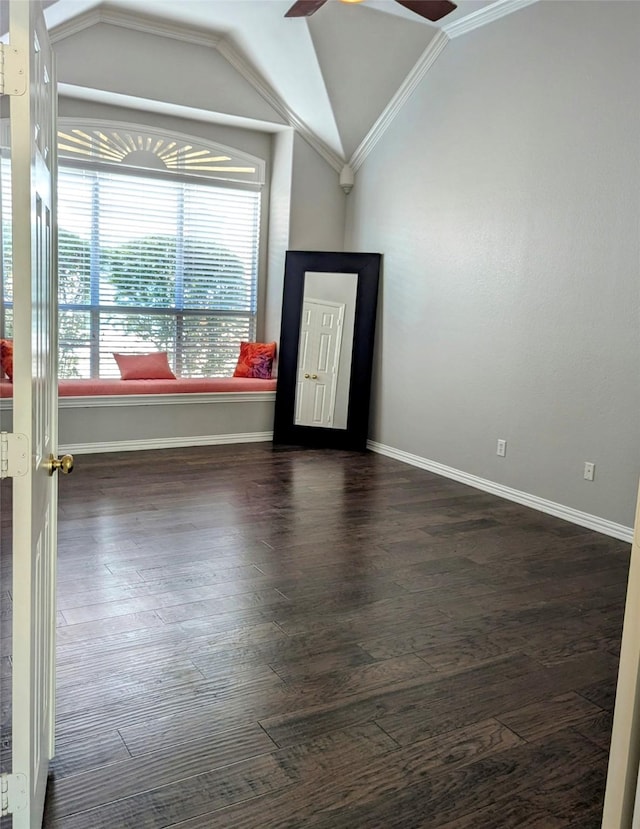 unfurnished room featuring dark hardwood / wood-style floors, ceiling fan, ornamental molding, and vaulted ceiling