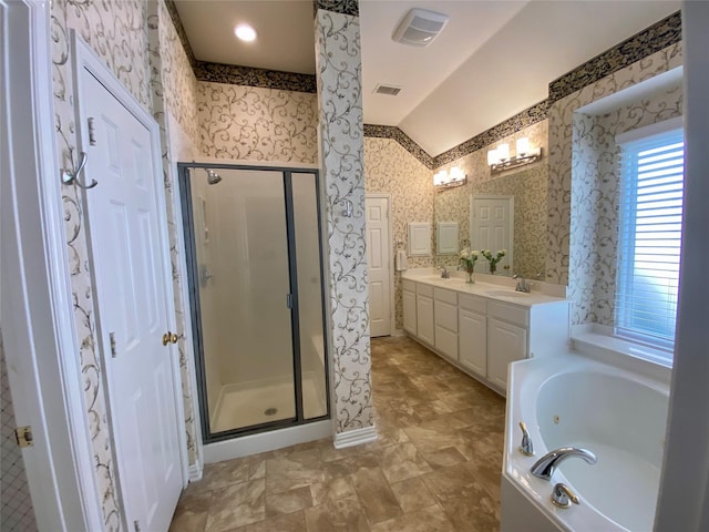 bathroom featuring separate shower and tub, vanity, and vaulted ceiling