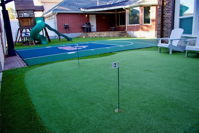 view of sport court with a playground