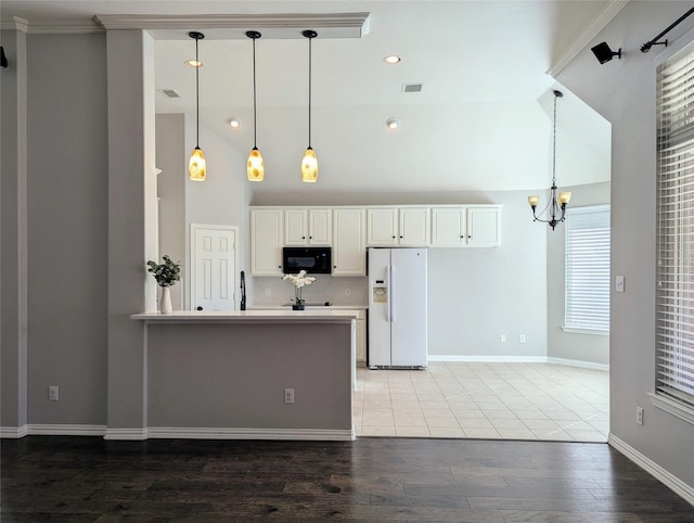 kitchen with white refrigerator with ice dispenser, crown molding, hanging light fixtures, hardwood / wood-style flooring, and white cabinetry