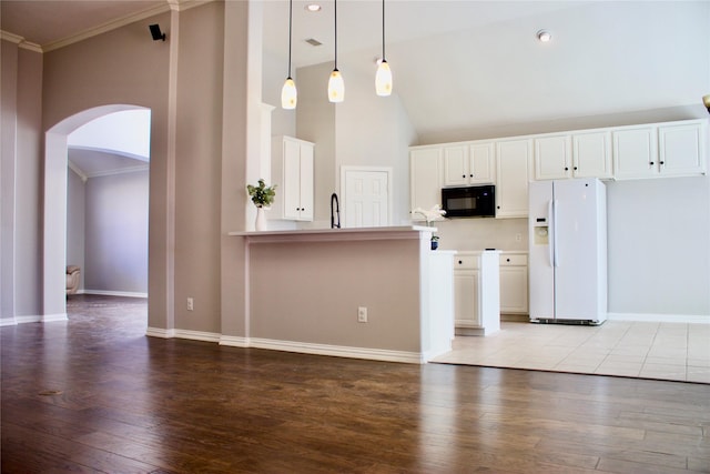 kitchen with light wood-type flooring, white refrigerator with ice dispenser, pendant lighting, high vaulted ceiling, and white cabinets