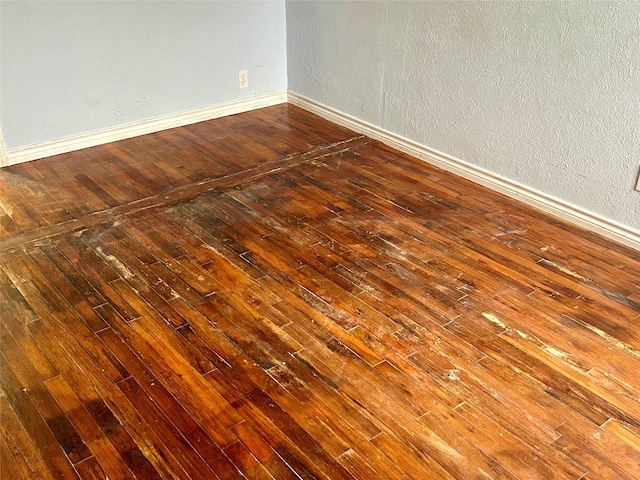 spare room featuring dark wood-type flooring