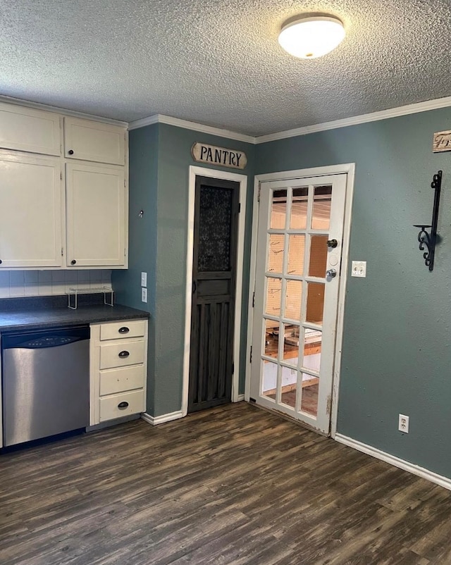 kitchen with white cabinets, dark hardwood / wood-style flooring, stainless steel dishwasher, and ornamental molding