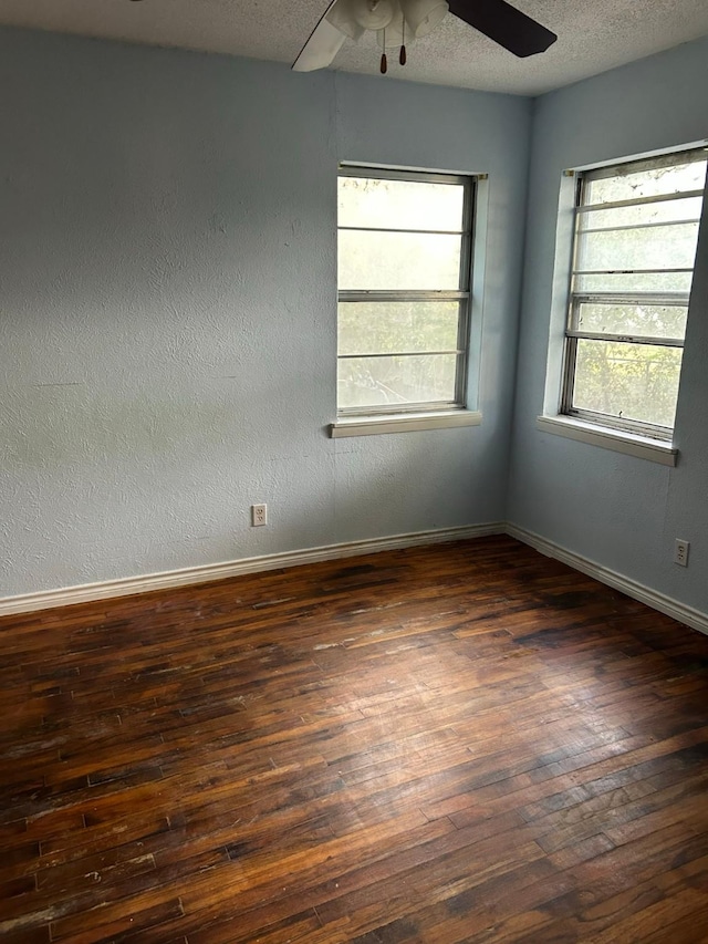 empty room with dark hardwood / wood-style flooring