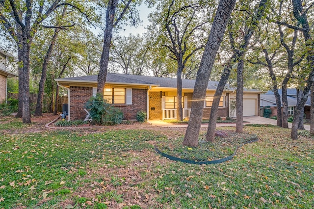 ranch-style house with a garage and a front lawn