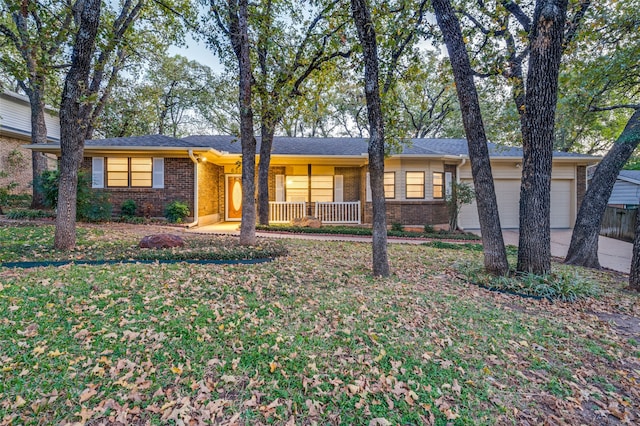 ranch-style house featuring a porch and a garage