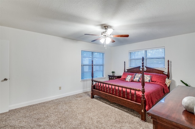 bedroom with carpet flooring, ceiling fan, and a textured ceiling