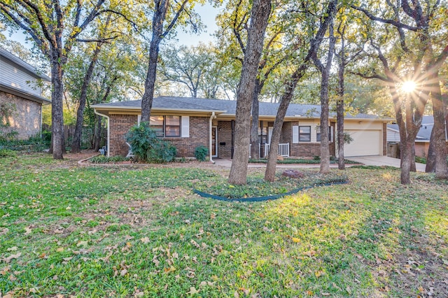 ranch-style home featuring a garage and a front lawn