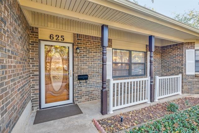 view of exterior entry featuring a porch