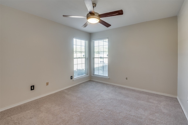 spare room featuring ceiling fan and light colored carpet