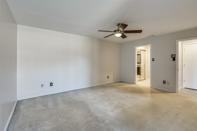 carpeted spare room featuring ceiling fan