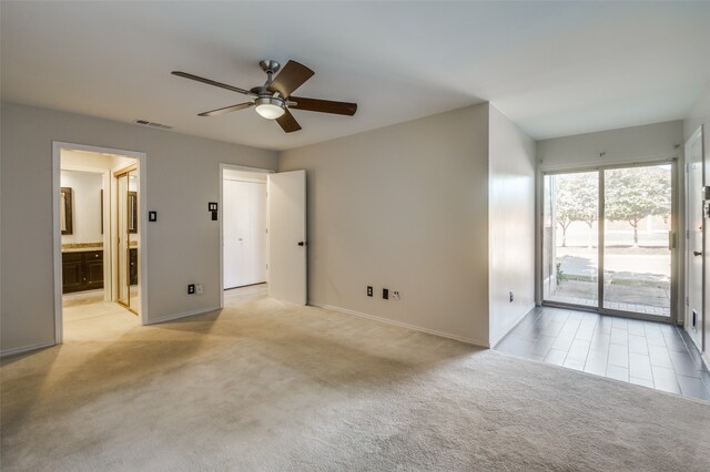 carpeted spare room with ceiling fan