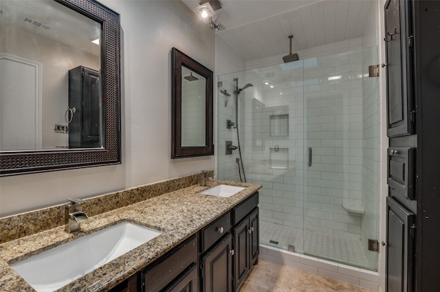 bathroom featuring tile patterned floors, vanity, and a shower with shower door