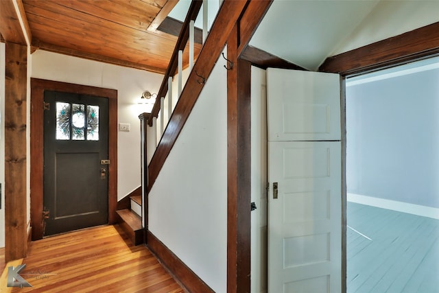 foyer with light hardwood / wood-style floors, lofted ceiling, and wood ceiling