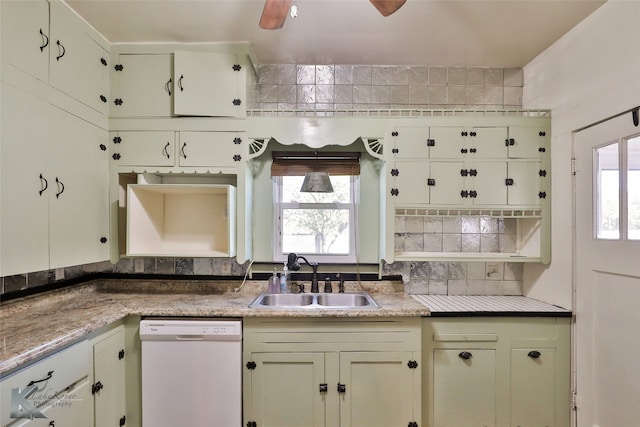 kitchen featuring light stone counters, dishwasher, and sink