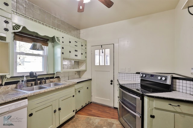 kitchen with backsplash, white dishwasher, sink, light hardwood / wood-style flooring, and stainless steel electric range oven