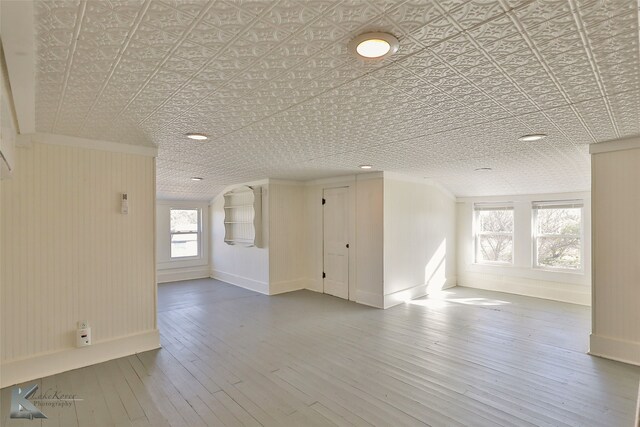 unfurnished room featuring wood-type flooring and a textured ceiling