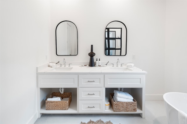 bathroom with a washtub and vanity